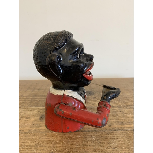 232 - A cast iron hand painted money box with moving eyes, 6