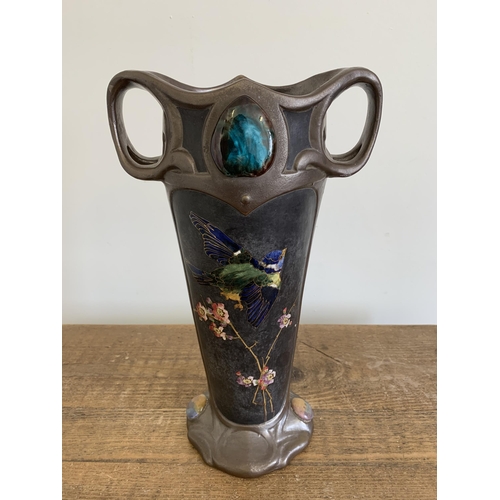 235 - An imposing Art Nouveau Bretby vase with hand painted birds with gilded outline and Ruskin style pla... 