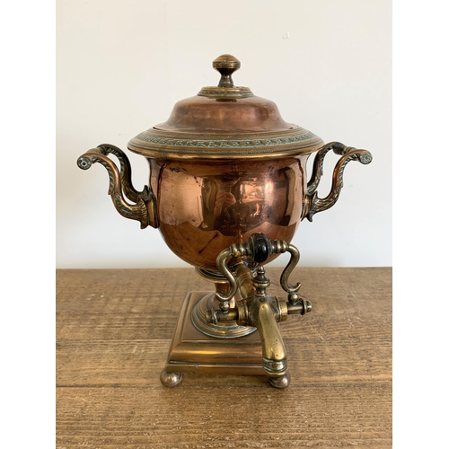 241 - A late Georgian copper and brass samovar on four ball feet