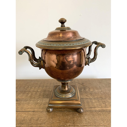 241 - A late Georgian copper and brass samovar on four ball feet