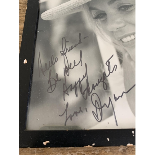 246 - Two framed and glazed autographed photographs of actress Dyan Cannon, 9 3/4