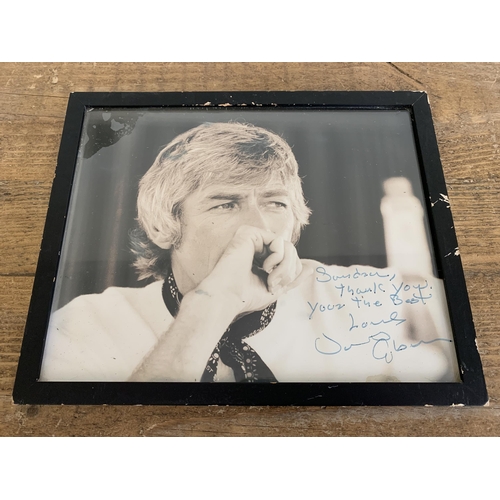 248 - A framed and glazed autographed photo of actor James Coburn, 9 3/4