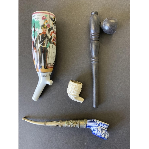 26 - An Imperial German Regimental pipe bowl (hairline crack), two opium pipes and a clay bowl