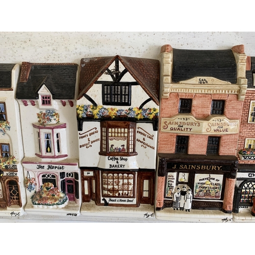 266 - A mounted run of 13 'Hazel Ceramics' shops including J Sainsbury, Thomas Cook, Rose & Crown pub etc,... 