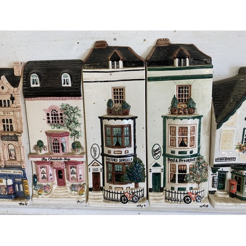 266 - A mounted run of 13 'Hazel Ceramics' shops including J Sainsbury, Thomas Cook, Rose & Crown pub etc,... 