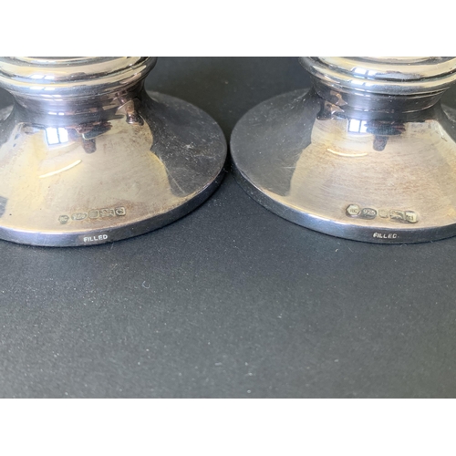 269 - A pair of small hallmarked silver candlesticks, 2 3/4