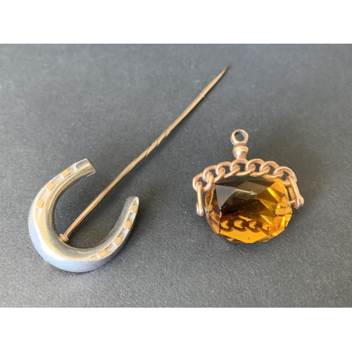 271 - A yellow metal citrine stone set swivel fob plus a yellow and white metal horseshoe stick pin