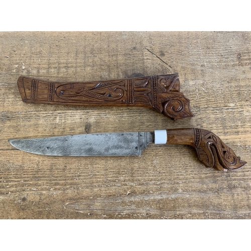 278 - A vintage Borneo 'Gunong' knife in carved wood scabbard with carved handle, blade length 10 1/2