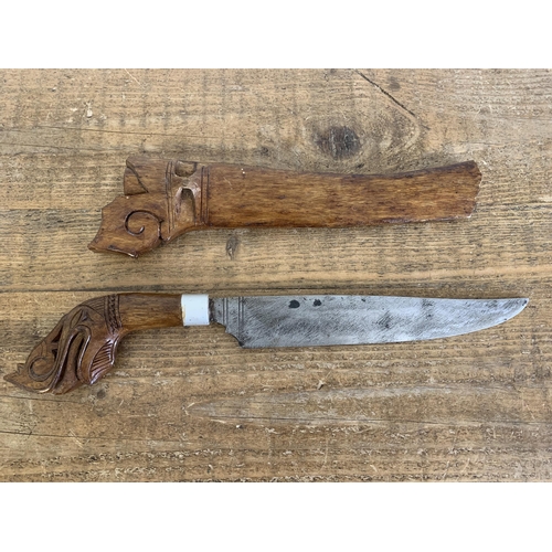 278 - A vintage Borneo 'Gunong' knife in carved wood scabbard with carved handle, blade length 10 1/2