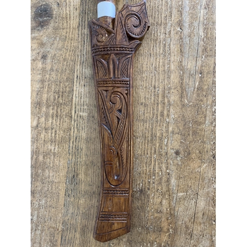 278 - A vintage Borneo 'Gunong' knife in carved wood scabbard with carved handle, blade length 10 1/2