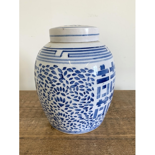 296 - A vintage Oriental blue and white lidded ginger jar, approx. 9