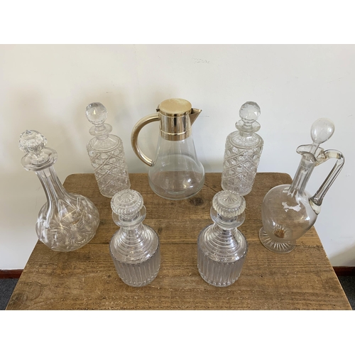 299 - A large white metal and glass claret jug together with one other, a pair of cut glass decanters (as ... 