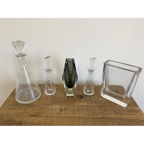 300 - A heavy cut glass vase, maker marked to base, a decanter and two oil bottles plus a Murano style vas... 