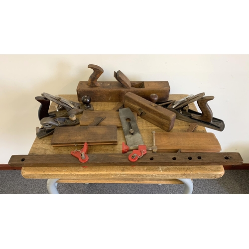 31 - A large vintage Stanley plane, a small Record plane plus a selection of wood planes and a clamp