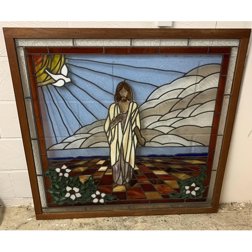 363 - A large wood framed leaded glass panel with painted face of Jesus with a dove, total size 45