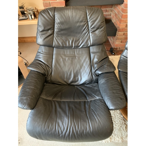 371 - A pair of black leather adjustable armchairs with wood bases and matching foot stool (signs of use)