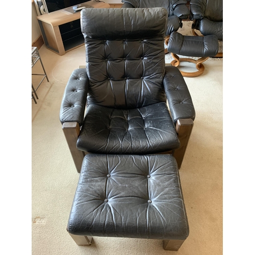 374 - A pair of vintage button back black leather adjustable armchairs, both with matching foot stools (ag... 