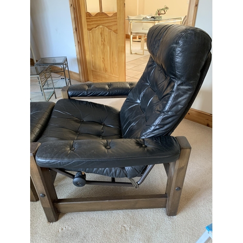 374 - A pair of vintage button back black leather adjustable armchairs, both with matching foot stools (ag... 