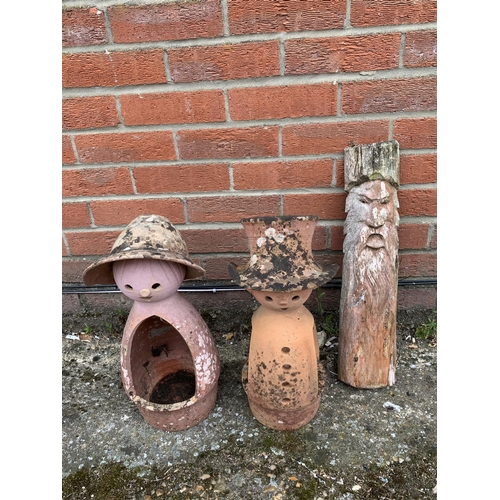 406 - Two terracotta garden figure planters plus a wood carving