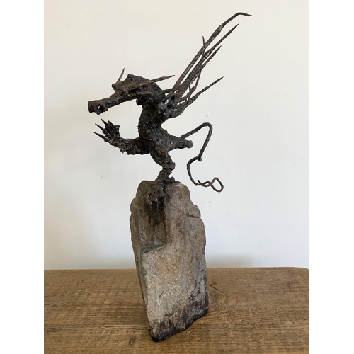 57 - An unusual winged dragon made from metal and mounted on a solid base, approx. 20