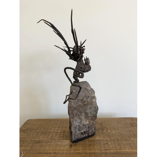 57 - An unusual winged dragon made from metal and mounted on a solid base, approx. 20