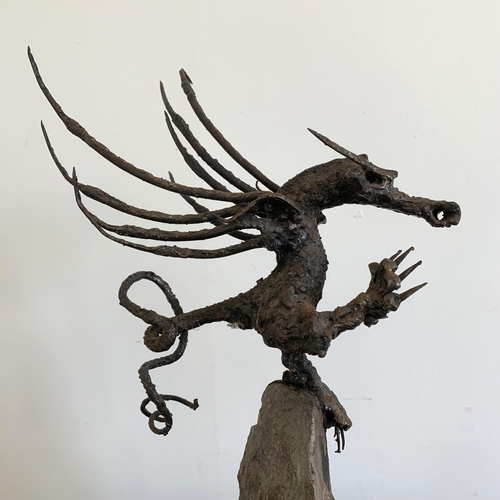 57 - An unusual winged dragon made from metal and mounted on a solid base, approx. 20