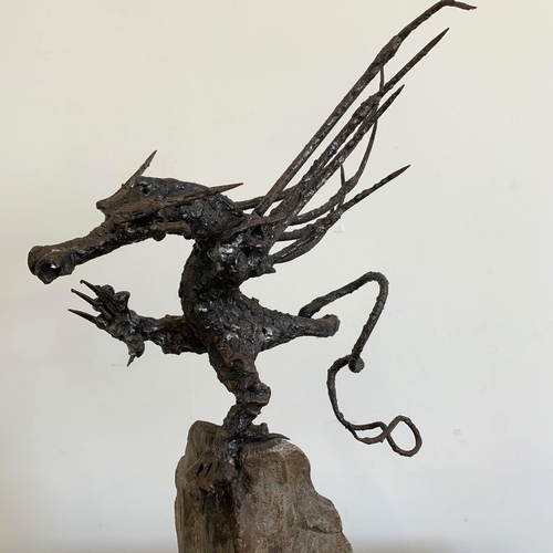 57 - An unusual winged dragon made from metal and mounted on a solid base, approx. 20