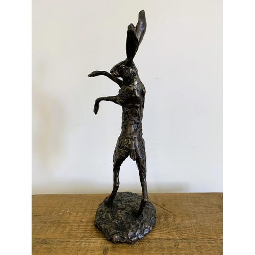 58 - A bronzed resin 'dancing hare', approx. 20