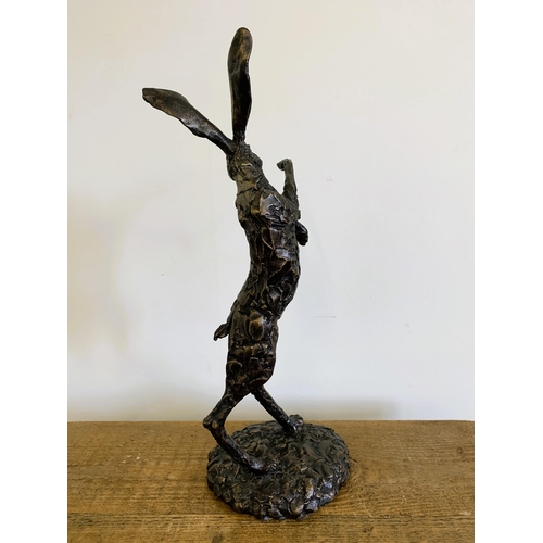 58 - A bronzed resin 'dancing hare', approx. 20