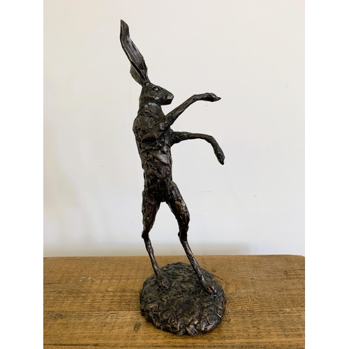 58 - A bronzed resin 'dancing hare', approx. 20