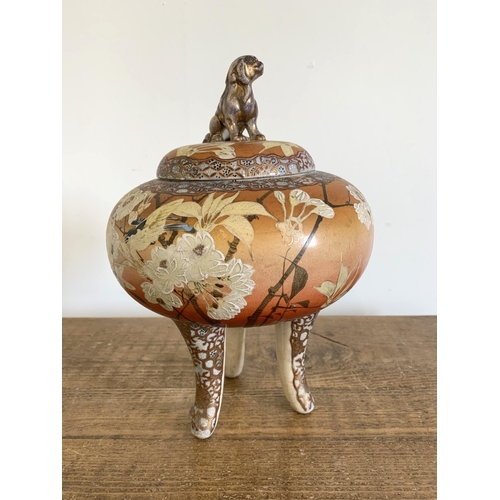 68 - An antique Japanese Satsuma three legged koro with Dog of Fo mounted lid, the body decorated with ch... 