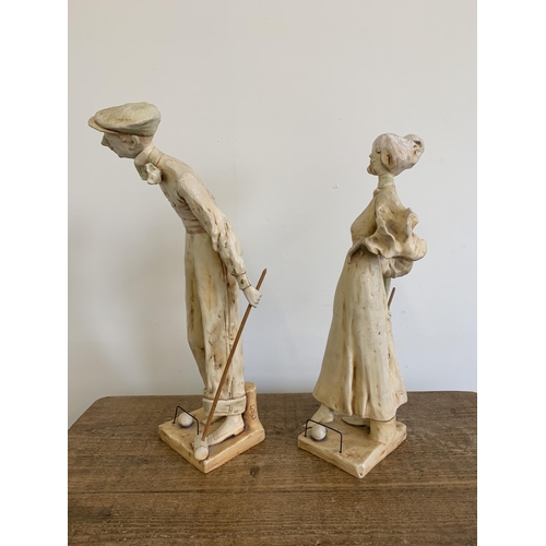 69 - A pair of early 20th Century Art Nouveau Austrian ceramic figurines of croquet players, the tallest ... 