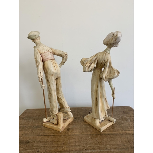 69 - A pair of early 20th Century Art Nouveau Austrian ceramic figurines of croquet players, the tallest ... 