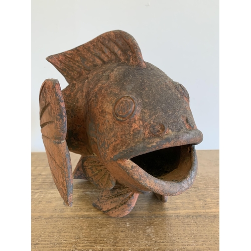 77 - A vintage stoneware leaping fish, original worn orange paint, approx. 10