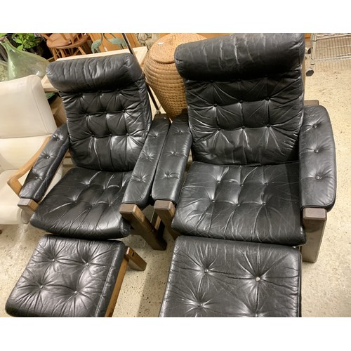 374 - A pair of vintage button back black leather adjustable armchairs, both with matching foot stools (ag... 