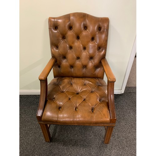 436 - A brown leather Chesterfield style chair (used and wear to arms)