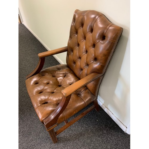 436 - A brown leather Chesterfield style chair (used and wear to arms)