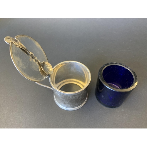 101 - A hallmarked silver mustard pot with blue glass liner and small spoon together with a hallmarked pep... 