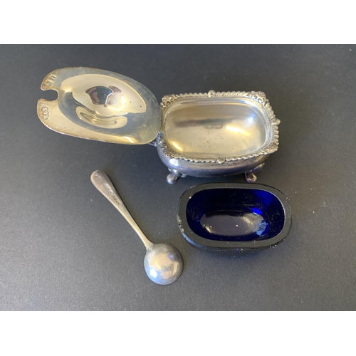 102 - A three piece hallmarked silver condiment set including open salt with blue glass liner, pepper and ... 