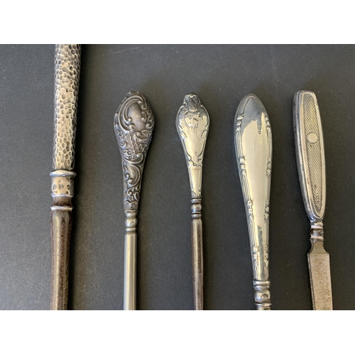 104 - Five hallmarked silver handle items including two button hooks, one with Chester mark, a very long b... 