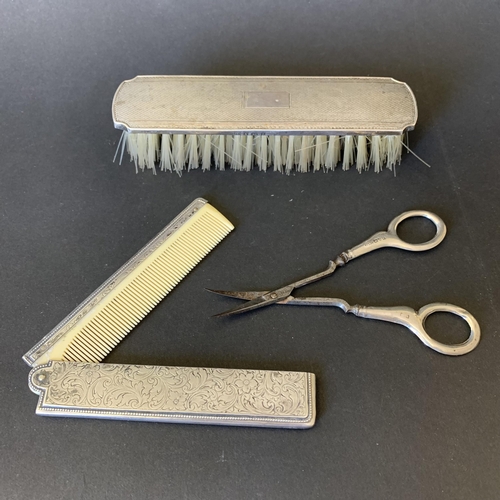 107 - An 800 grade silver folding comb together with Chester hallmark handle scissors and a silver clothes... 