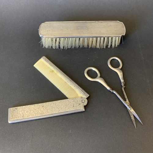 107 - An 800 grade silver folding comb together with Chester hallmark handle scissors and a silver clothes... 