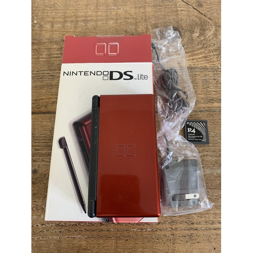 35 - A boxed Nintendo DS Lite handheld unit plus four games, stylus and adapter (signs of use, untested)