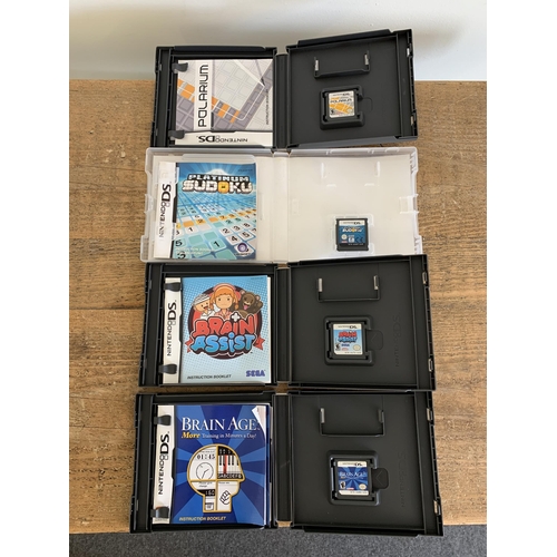 35 - A boxed Nintendo DS Lite handheld unit plus four games, stylus and adapter (signs of use, untested)