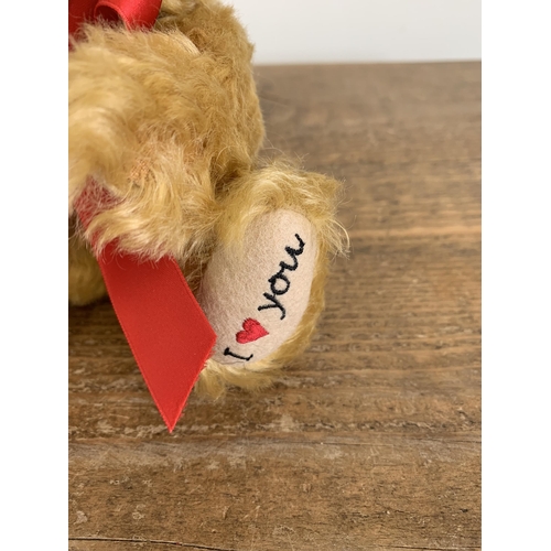 49 - A boxed Steiff teddy bear with rose 'I Love You', approx. height 8 1/2