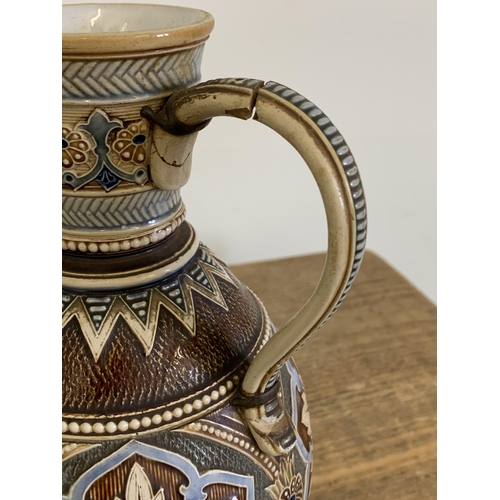 86 - A vintage Art Nouveau period Royal Doulton tobacco jar (lacking lid) plus an Austrian Mettlach jug, ... 