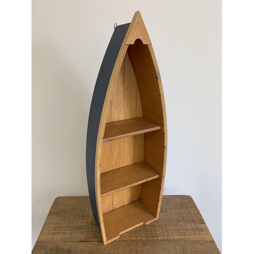 88 - A wooden boat shaped display stand, 30 3/4