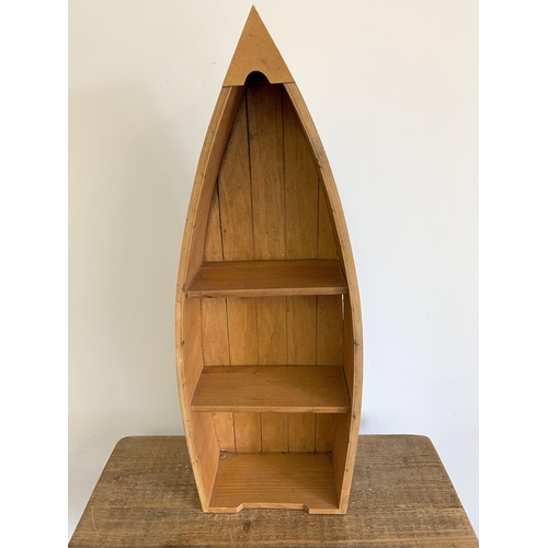 88 - A wooden boat shaped display stand, 30 3/4