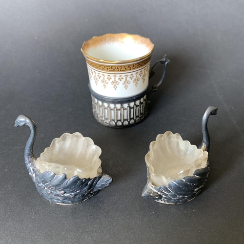 100 - A hallmarked silver cup holder with an Aynsley china cup plus a pair of 800 grade silver swan salts