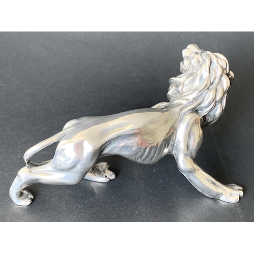 131 - A large lion figure constructed from a resin core with a 925 sterling silver skin, small button on b... 